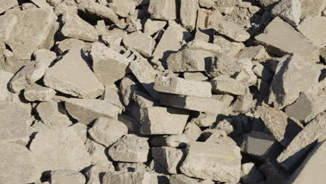 panning close-up of rocks and concrete from a demolished building