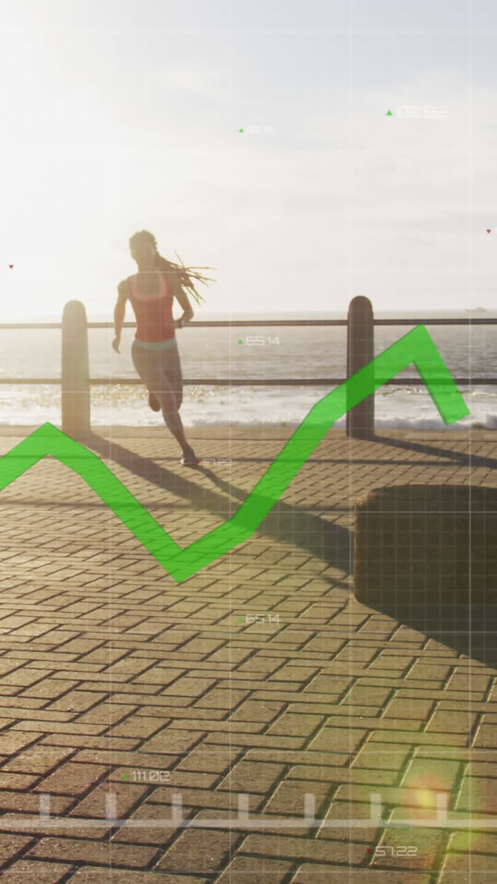 gráfico verde moviéndose contra afroamericano mujer en forma corriendo en el paseo marítimo