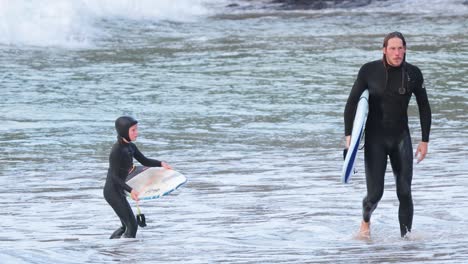 father and son bonding while surfing together