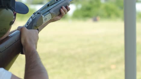 sportsman shoots from a double-barreled shotgun, a sports field for a shooting test is shooting at flying skeet