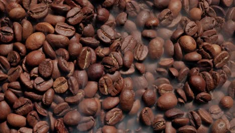 Close-up-of-seeds-of-coffee.-Fragrant-coffee-beans-are-roasted-smoke-comes-from-coffee-beans.