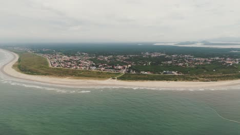 Aerial-view-of-long-beach-and-urban-town-of-Pontal-do-Sul-in-Paraná,-Brazil,-Drone-4k