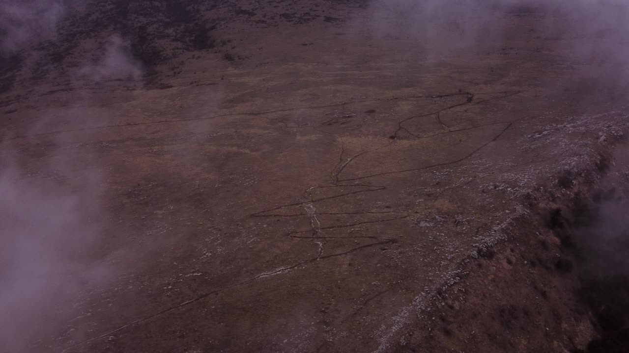 Spooky fog over the walking trail in mountains