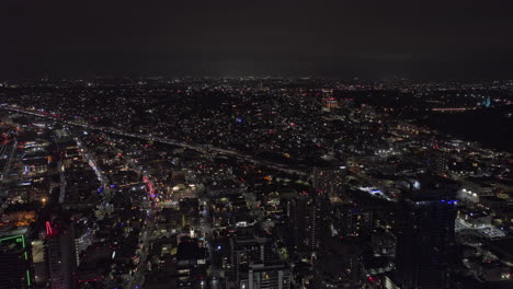 San-Diego-California-Aerial-v108-panoramic-panning-view-capturing-buzzing-downtown-cityscape-and-plane-flying-across-the-sky-landing-at-the-airport-at-night---Shot-with-Mavic-3-Cine---September-2022