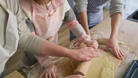 video of grandma helping her granddaughter rolling dough