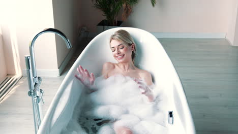 woman relaxing in a bathtub with bubbles