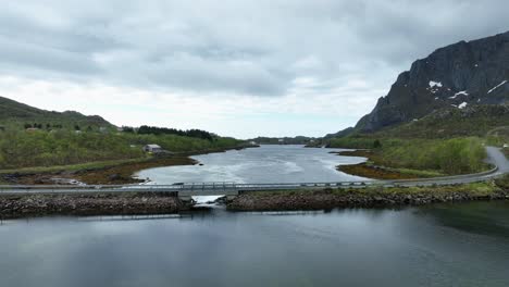 view over hopspollen in lofoten showing bridge, road to hopen, sea and coastal landscape near oersvaag