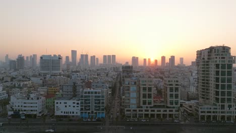 Tel-Aviv-coastline-at-sunrise-with-beautiful-calm-waters-of-The-Mediterranean-Sea,-Waterfront-hotels-and-light-sun-flare