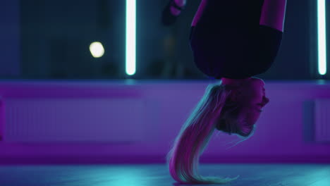 Woman-hanging-upside-down-and-using-yoga-hammock-swing-while-doing-antigravity-yoga-exercise.-Back-view-of-beautiful-young-woman-using-hammock-for-doing-pose-of-antigravity-yoga