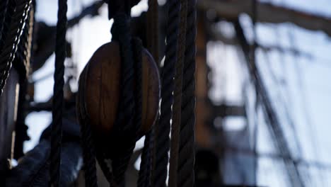 old naval warship rigging shallow depth of field with sun glare at sea concept