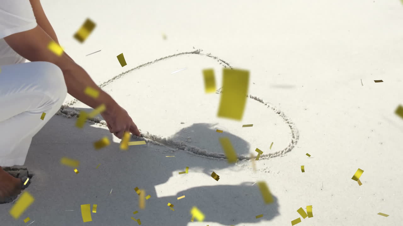 Drawing heart shape in sand, person surrounded by falling confetti animation
