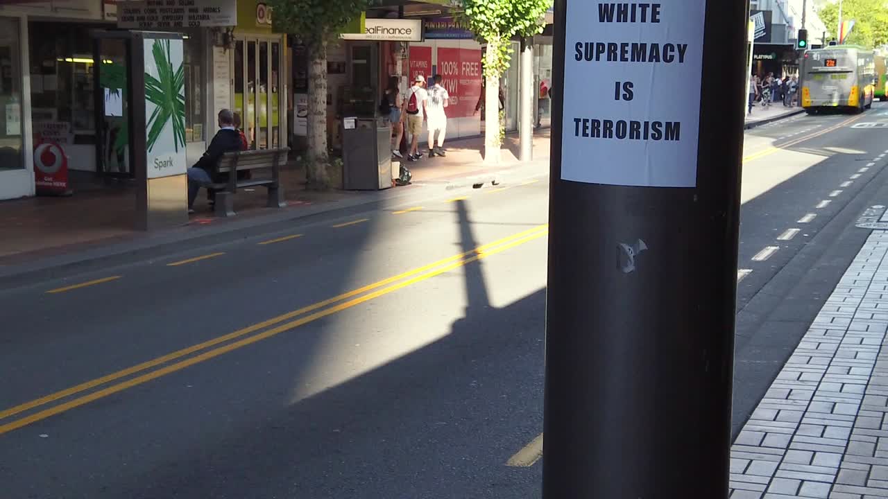 Slow motion tilt up revealing slogan "White supremacy is racism".