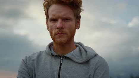 guy looking at camera. exhausted jogger feeling tired after cardio workout