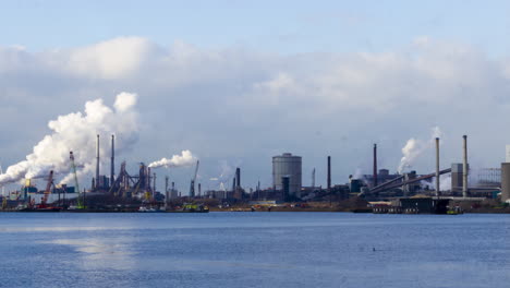 time lapse of polluting industrial area near harbor - zoom in