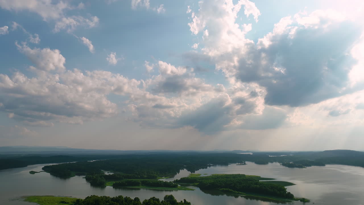Sunlight Behind Cloudscape Over Green Lush Islands In Spadra Park In Clarksville, Arkansas USA