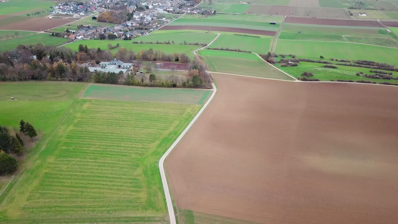 Small village surroundet by a lot Harvesting Fields