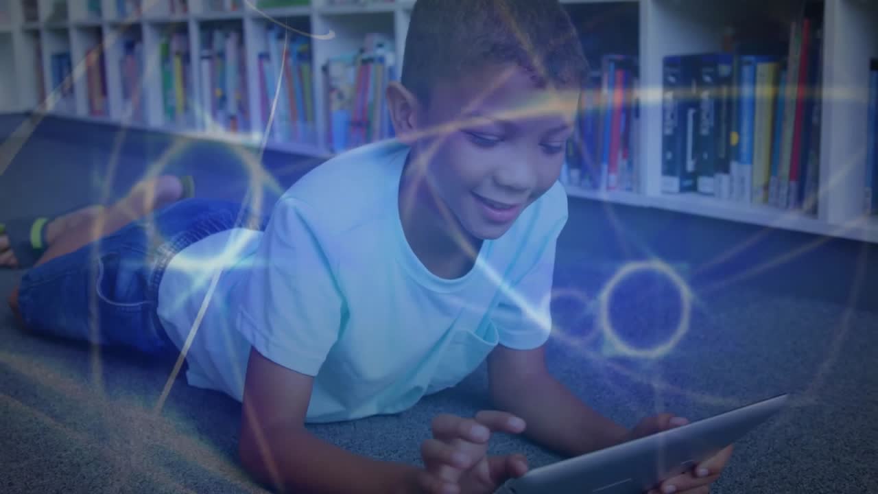 Animation of network of connected circles over happy african american boy using tablet