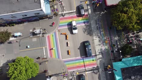 3-3 aerial twist panaramic birds eye view above davie and bute rainbow sidewalks in downtown vancouver's gay village coimmunity on sunny afternoon with covid-19 barriers on streets with light traffic