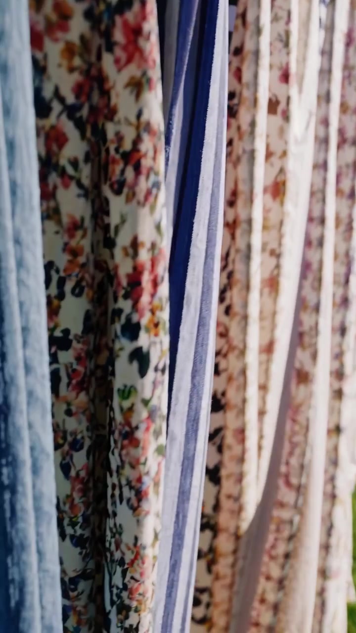 Colorful Clothes Drying on a Clothesline in a Sunny Backyard