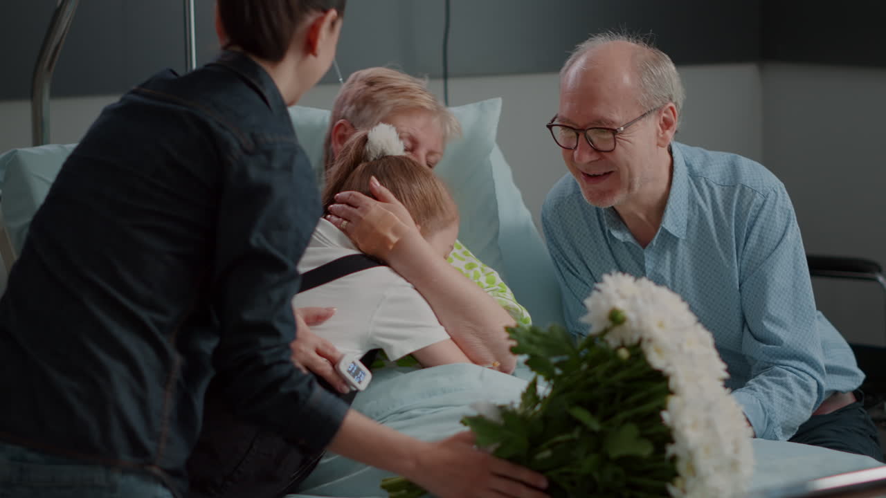 Close up of family surprising ill grandma in hospital ward