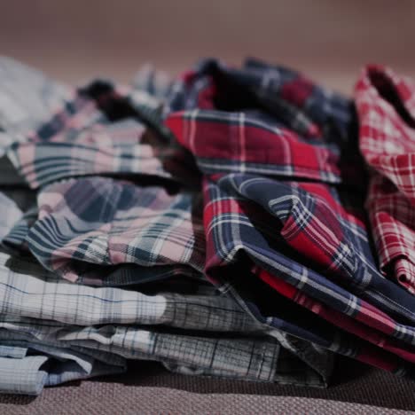 gently folded shirts lie on the shelf