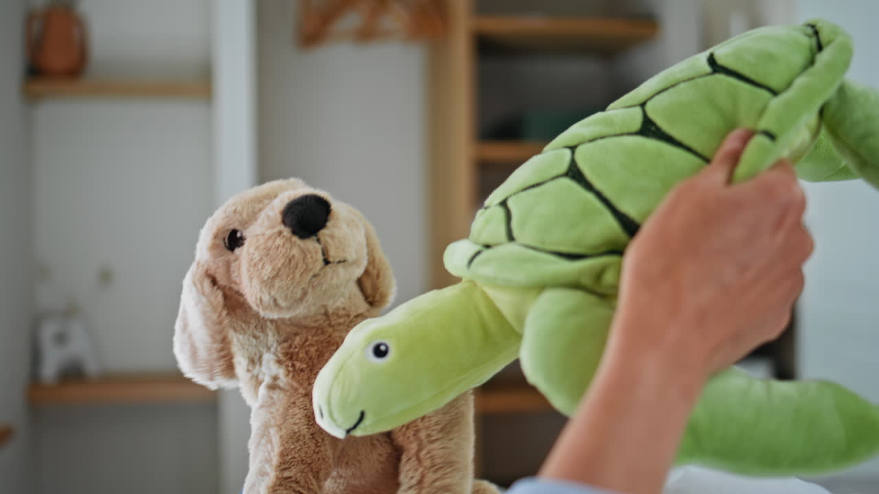 Mother daughter hands playing toys at bedroom closeup.Carefree family having fun