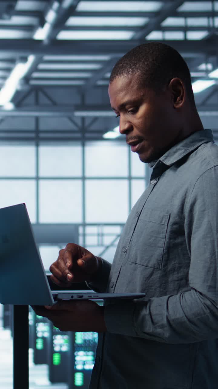 Vertical video Server farm workers using devices to perform vulnerability scans