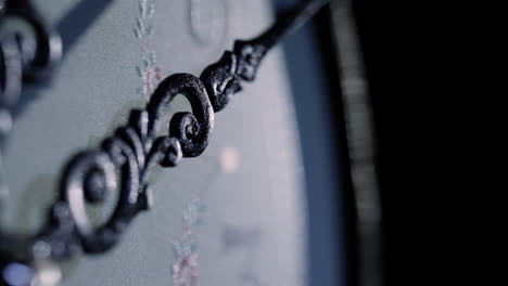 close-up-macro-of-an-old-clock-needle-ticking-in-studio-lighting