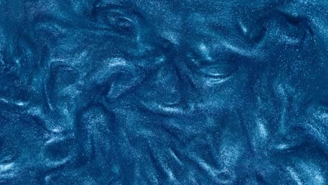 the blue glittering water slowly flows into beautiful abstract patterns