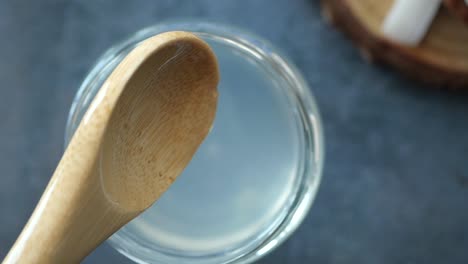 wooden spoon in a glass jar of liquid