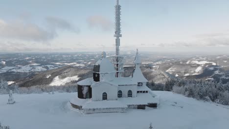 Closeup-and-part-orbit-at-the-Radhost-chappel-during-a-morning-golden-hour-in-winter,-Beskydy-4k