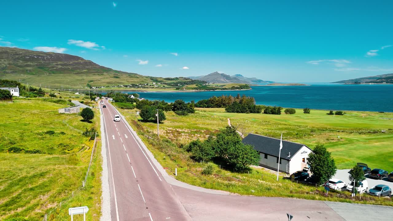 Aerial View of Scottish Highlands Landscape with Road and Vehicles