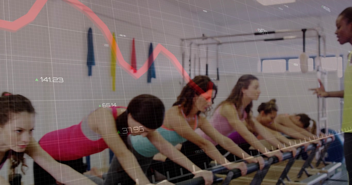 Participants leaning on barre pulsing fitness under instructor guiding gridlines+red graph tracking
