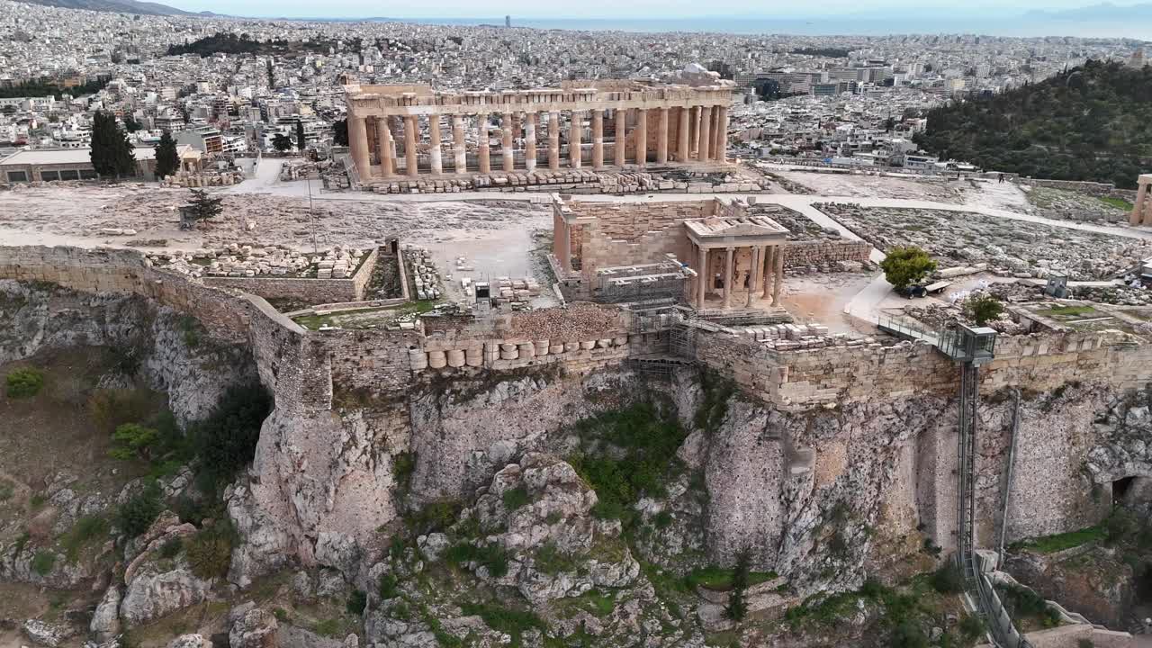 Athens,Ariel view backwards from Parthenon and Erechtheion towards greenery.Behind acropolis lies the city of Athens and the sea