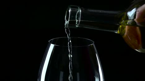 clear liquid being poured into a glass