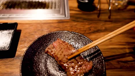 steak cooking on a hot stone with chopsticks