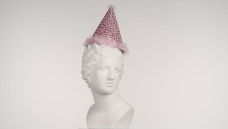 party hat on a classic statue