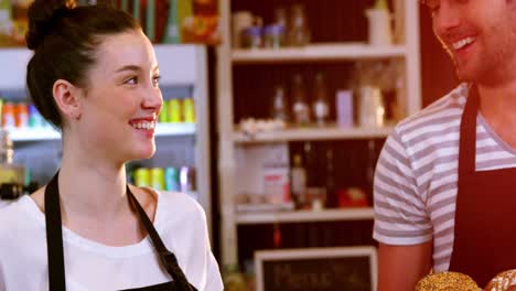 Waiter-and-waitress-holding-a-basket-of-bread-and-croissant