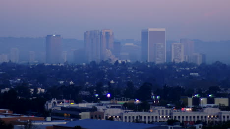 a time lapse night to day zoom back shot of los angeles downtown skyline california