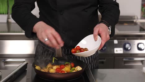 chef cooking with tomatoes and other ingredients