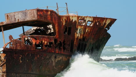 Old-weather-beaten-shipwreck-in-shallows-of-rocky-Cape-L'Agulhas-coastline