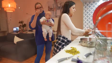 friends gathering and having dinner with a baby