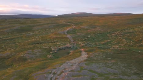 Arctic-nature-preparing-to-winter-and-mountain-biker-girl-enjoying-this-awesome-multitrack