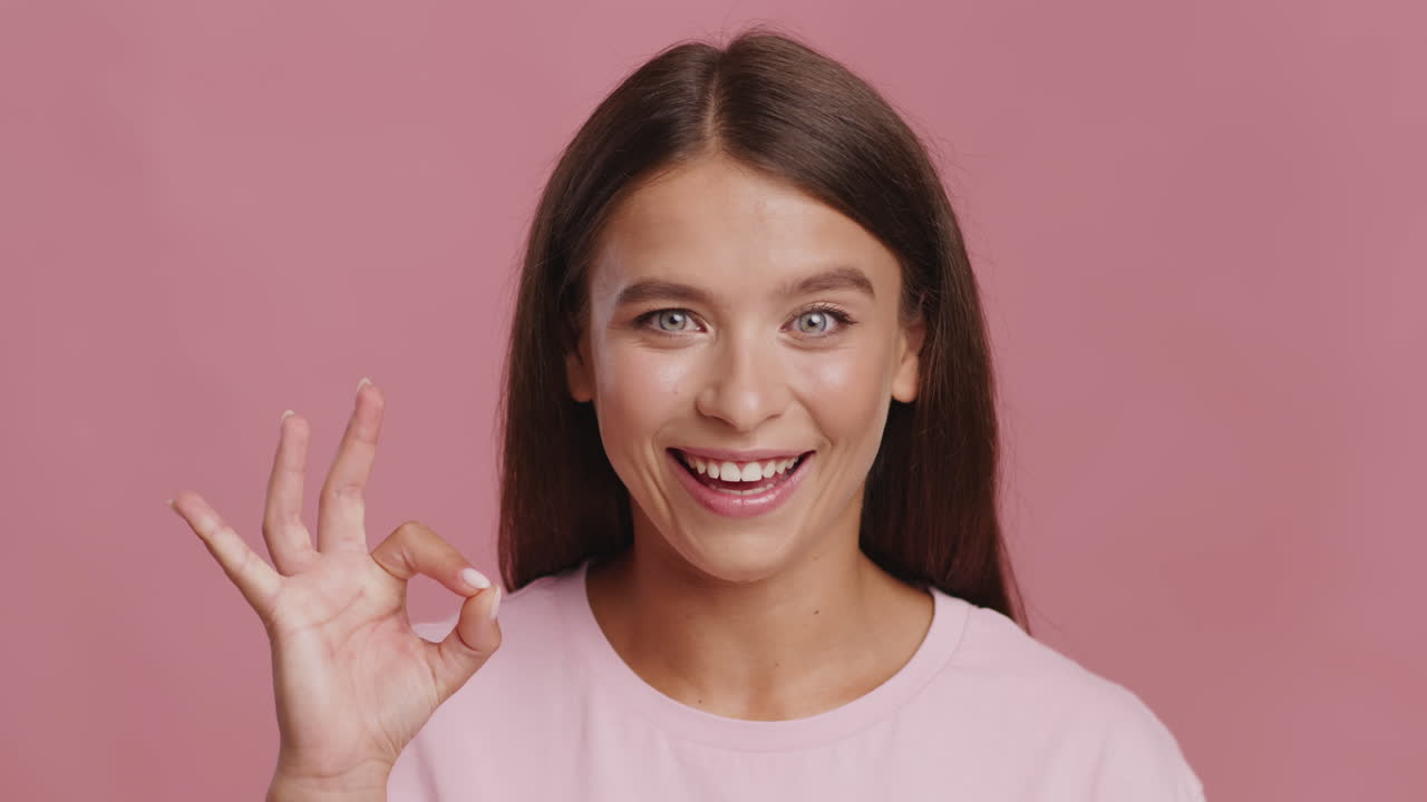 Smiling Woman Making Ok Gesture