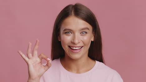 smiling woman making ok gesture