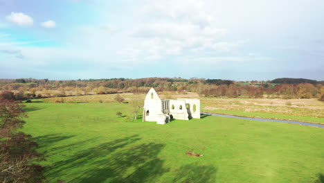 aerial view of a ruined church by a canal