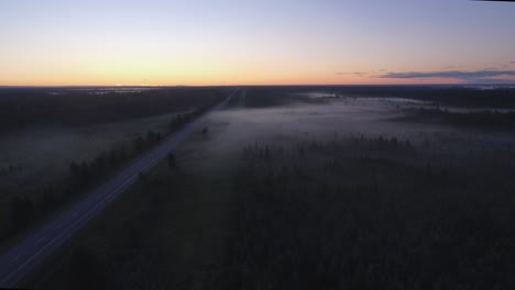 drone shot of thick fog blanketing the highway in the early morning on the east coast