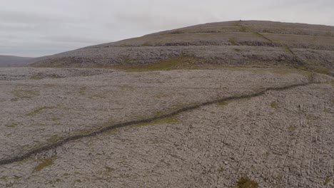Reverse-dolly-showcasing-a-rocky-hill-in-Burren-National-Park