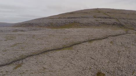 reverse dolly showcasing a rocky hill in burren national park