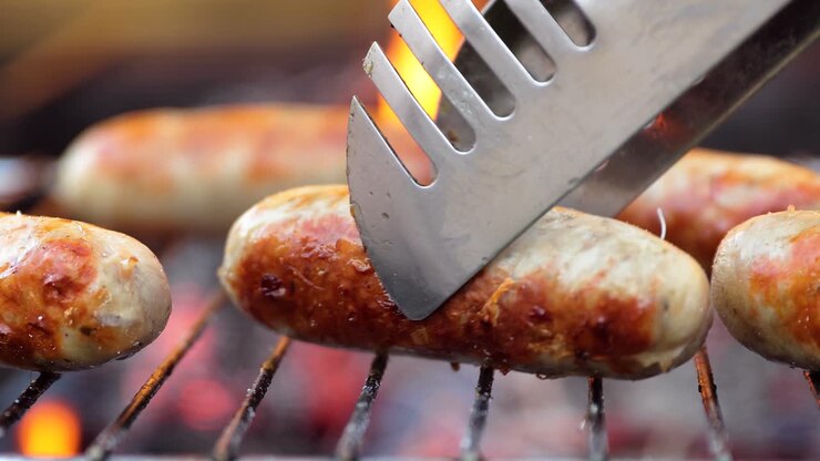 Delicious juicy sausages, cooked on the grill with a fire